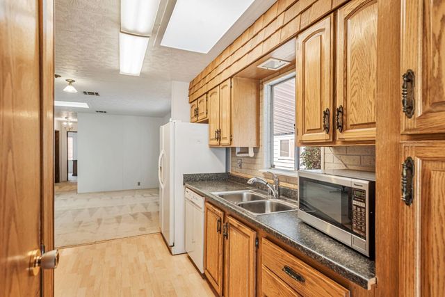 a kitchen with stainless steel appliances granite countertop a refrigerator and a stove