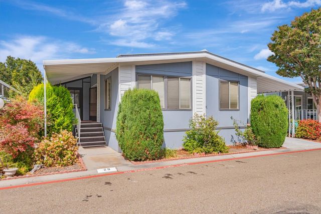 front view of a house with potted plants