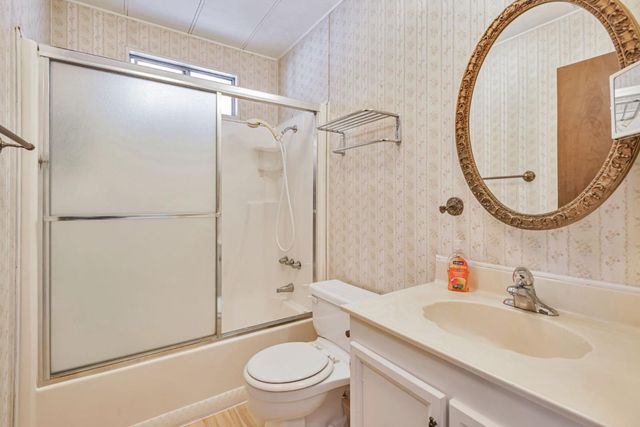 a bathroom with a sink toilet and a mirror