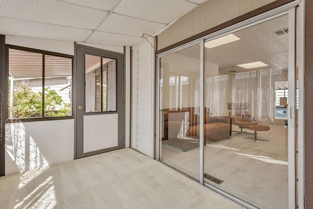 a view of a bathroom with a glass door and shower