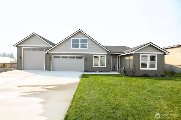 a view of a yard in front of a house with garage