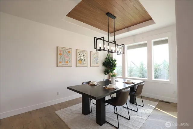 a view of a dining room with a table and chairs