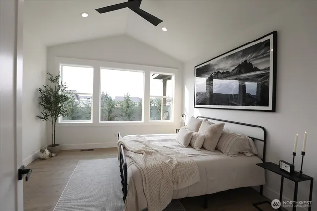 a bedroom with a bed and a large window