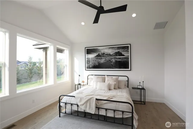 a bedroom with a bed and wooden floor