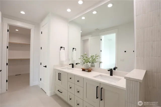 a bathroom with a sink double vanity and a mirror