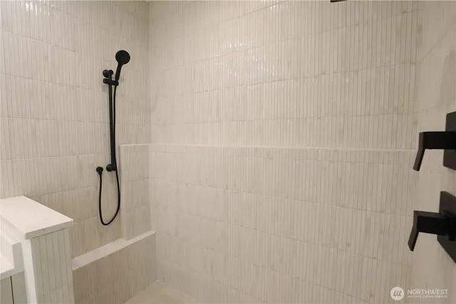 a bathroom with a shower and a sink