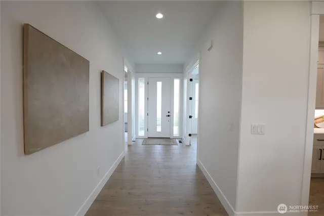 a view of a hallway with wooden floor