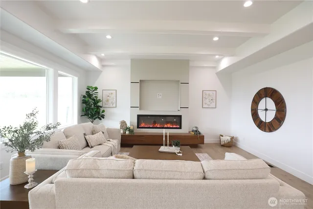 a living room with furniture a large mirror and a fireplace