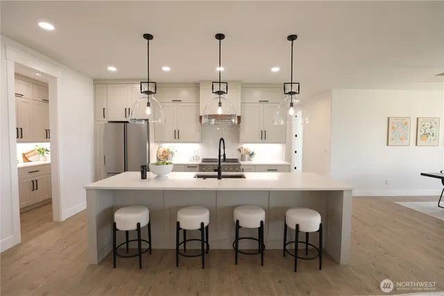a kitchen with cabinets and chairs
