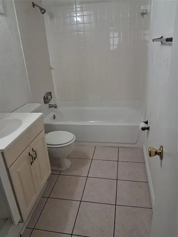 a white bath tub sitting next to a white toilet