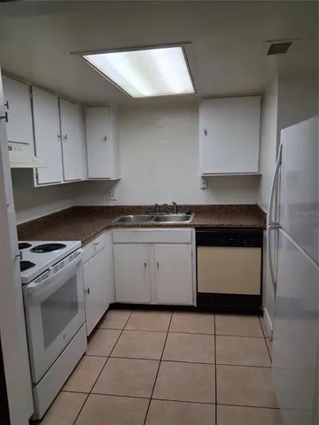 a kitchen with a stove a sink and a refrigerator
