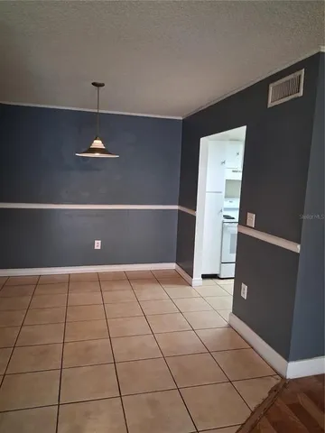 a view of kitchen with refrigerator and cabinets