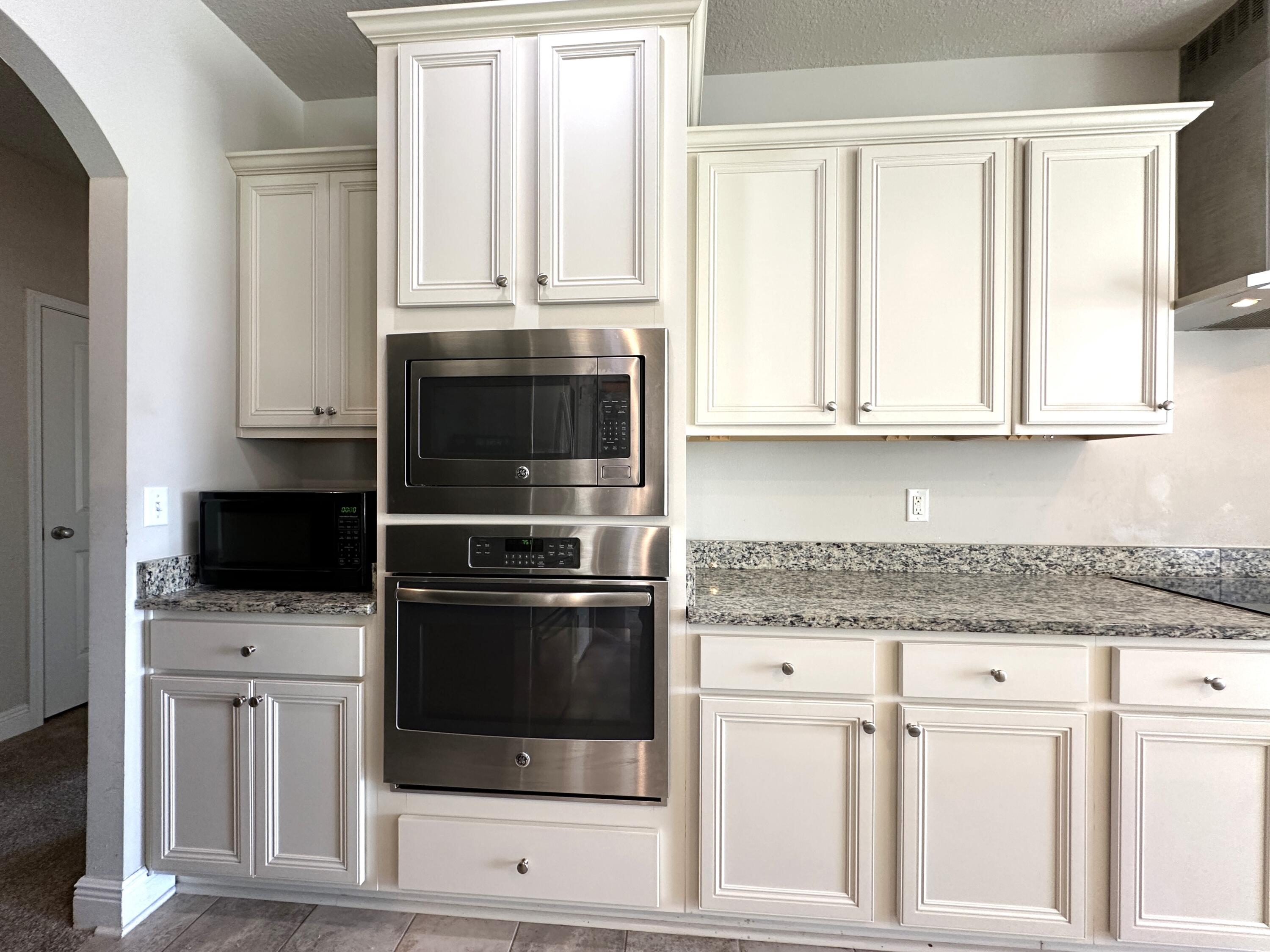 513 Gadwell Street Crestview, FL 32539 - Photo 11 of 35 a kitchen with granite countertop white cabinets stainless steel appliances and sink