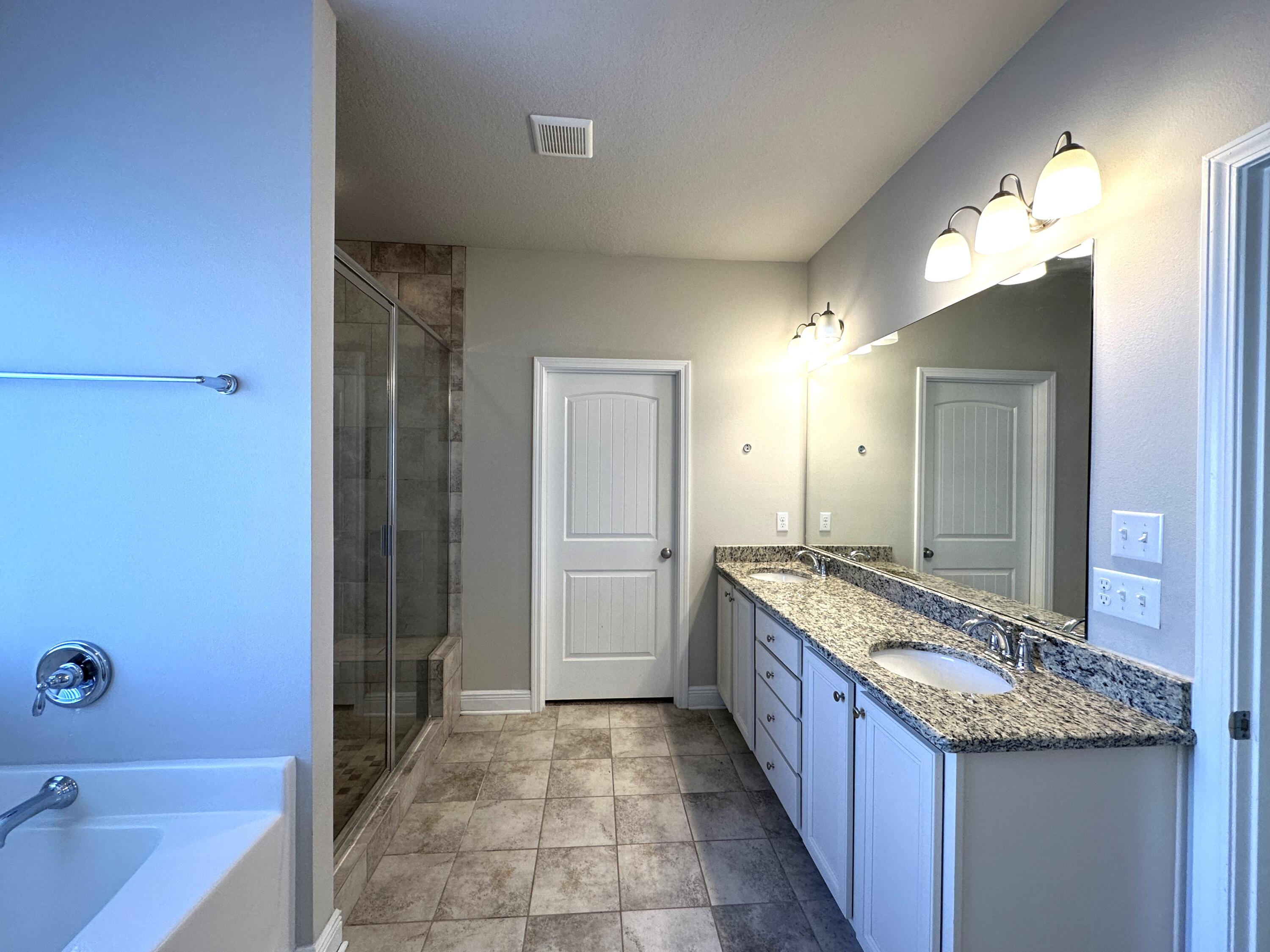 513 Gadwell Street Crestview, FL 32539 - Photo 17 of 35 a bathroom with a granite countertop sink and a mirror