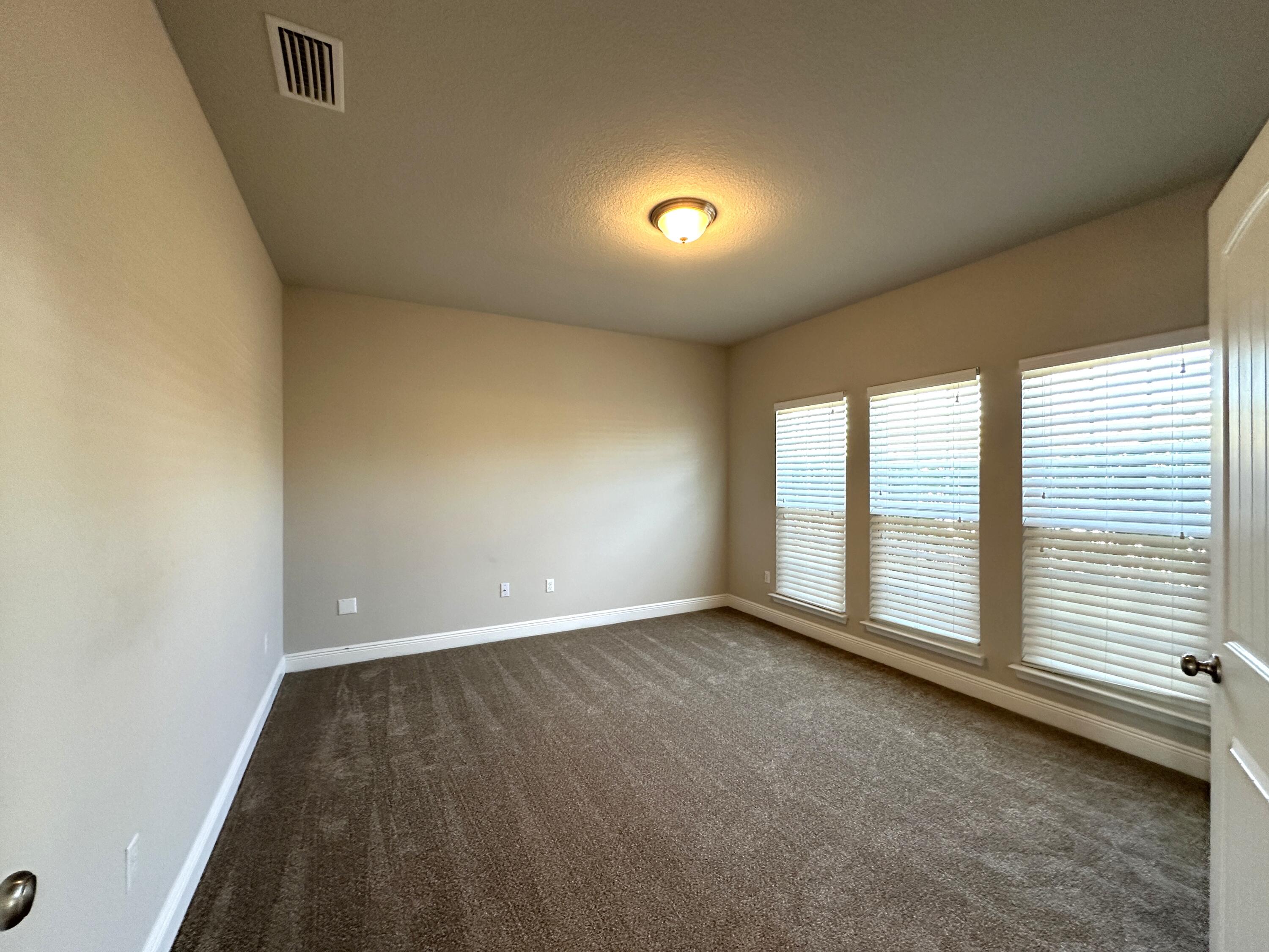 513 Gadwell Street Crestview, FL 32539 - Photo 4 of 35 an empty room with windows