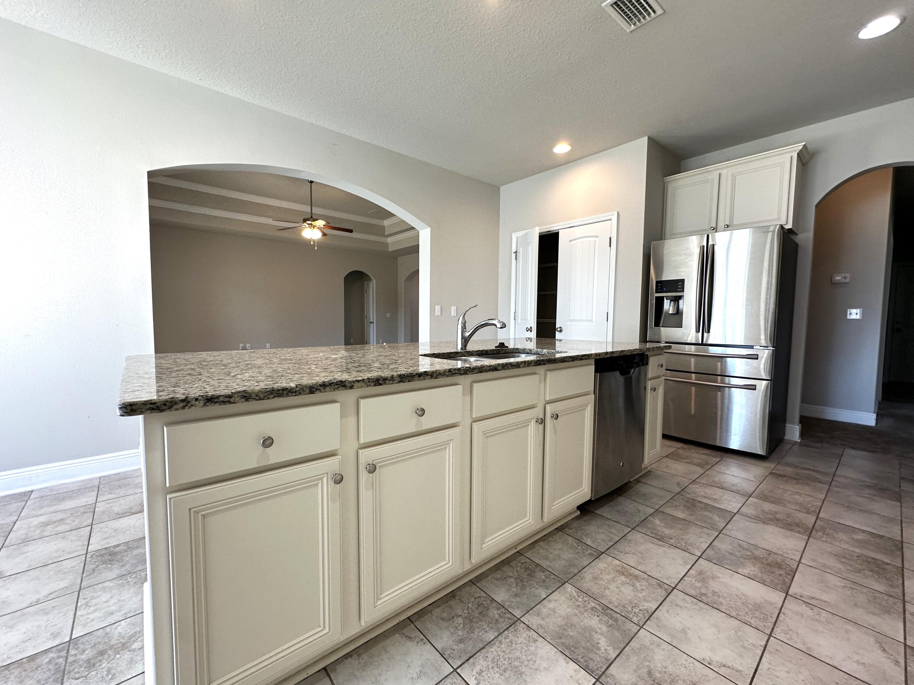 513 Gadwell Street Crestview, FL 32539 - Photo 10 of 35 a kitchen with a sink and refrigerator