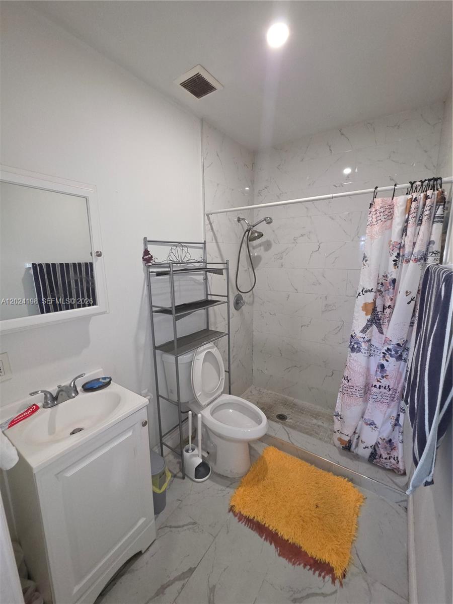 651 East 48th Street Hialeah, FL 33013 - Photo 36 of 52 a bathroom with a sink toilet and shower