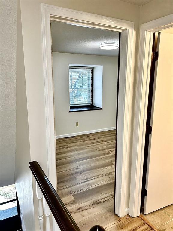 40 Corey Colonial, Unit 40 Agawam, MA 01001 - Photo 14 of 21 a view of a hallway with wooden floor and staircase