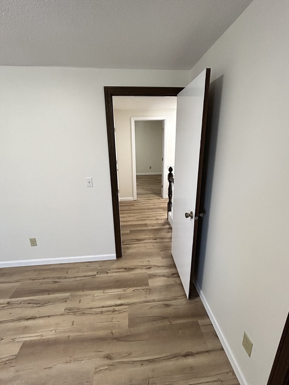 40 Corey Colonial, Unit 40 Agawam, MA 01001 - Photo 15 of 21 a view of a hallway with wooden floor and staircase