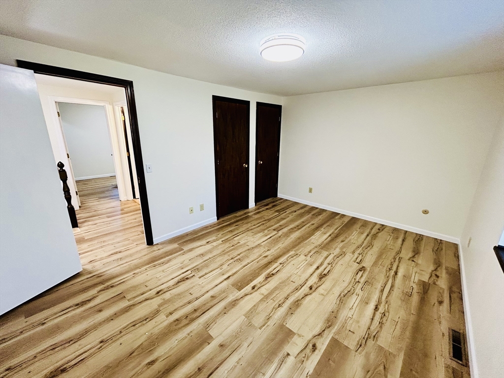 40 Corey Colonial, Unit 40 Agawam, MA 01001 - Photo 18 of 21 a view of empty room with wooden floor