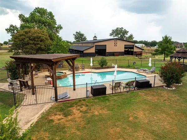 a view of a house with pool and chairs