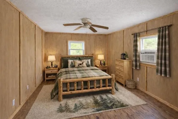 a living room with a bed next to a window
