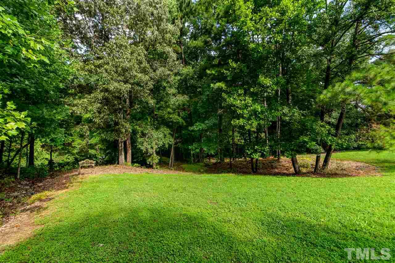 1117 Red Brick Road Garner, NC 27529 - Photo 22 of 24 a view of green field with trees in the background