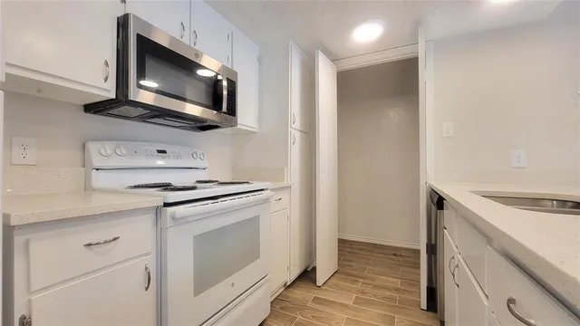 a kitchen with a stove microwave and sink