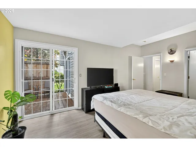 a bedroom with a bed and a flat screen tv