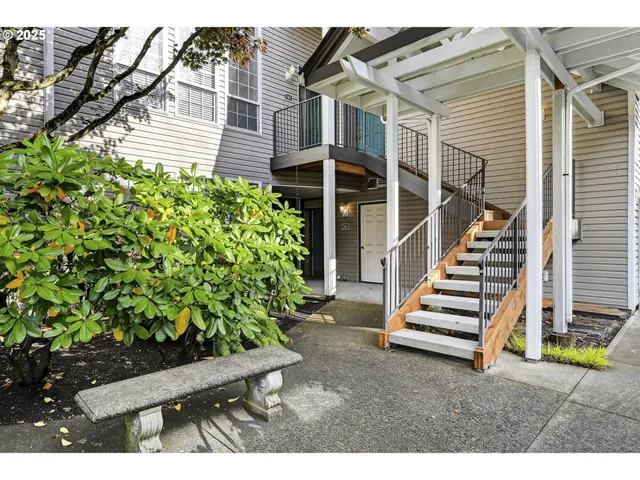 a view of a house with a yard and sitting area