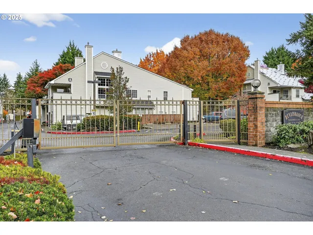 a view of a white house with a street