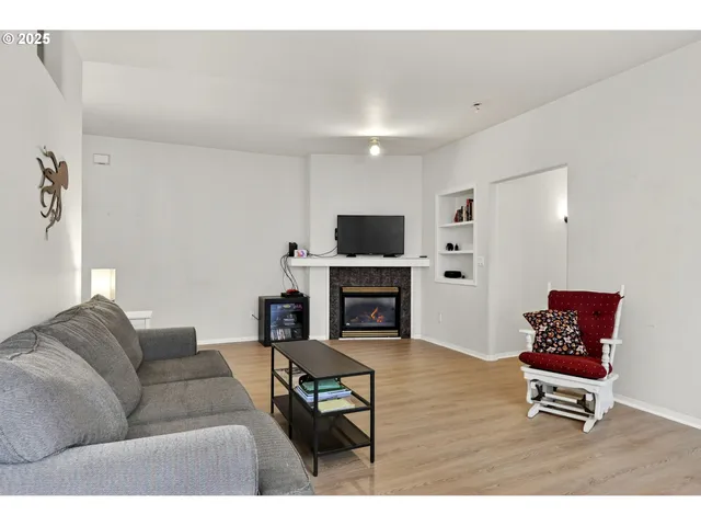 a living room with furniture a fireplace and a flat screen tv