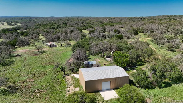 an aerial view of a house with a yard