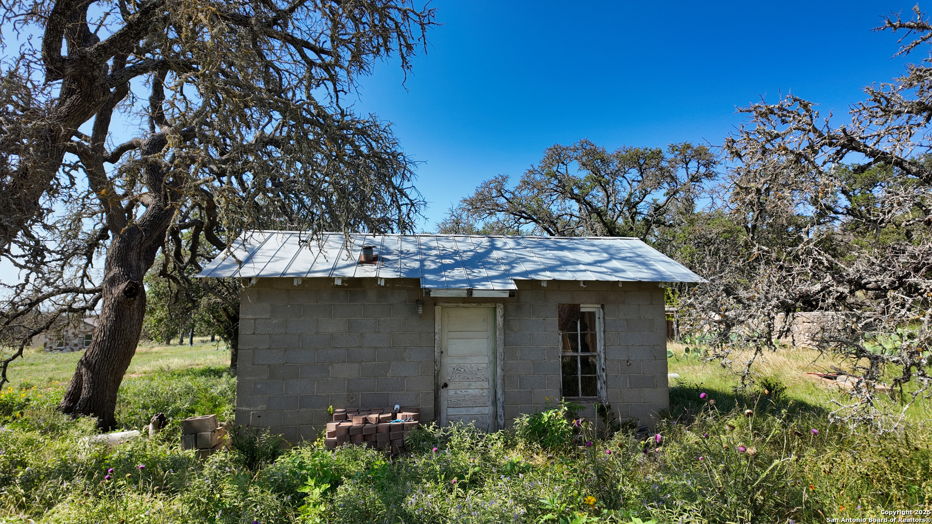 857 Dallas Josie Road Harper, TX 78631 - Photo 11 of 25 a view of a stone house with a tree