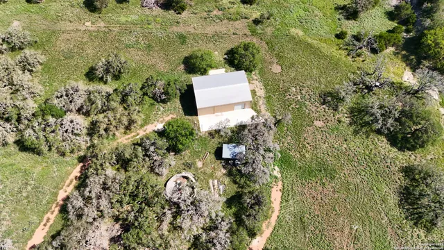 an aerial view of a house with a yard