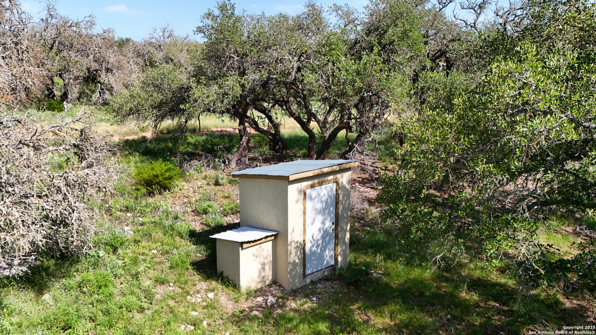 857 Dallas Josie Road Harper, TX 78631 - Photo 16 of 25 a view of a backyard with plants and a fountain