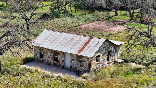 an aerial view of a house with a yard