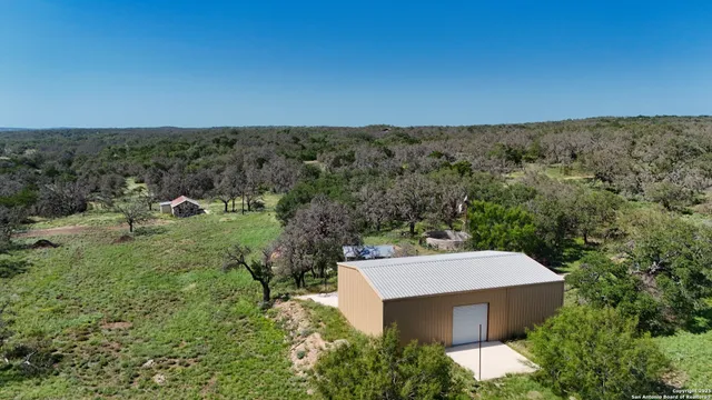 an aerial view of a house with a yard