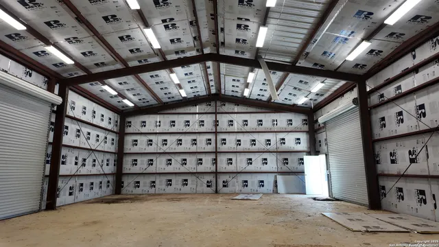 a view of a hallway with wooden shelves