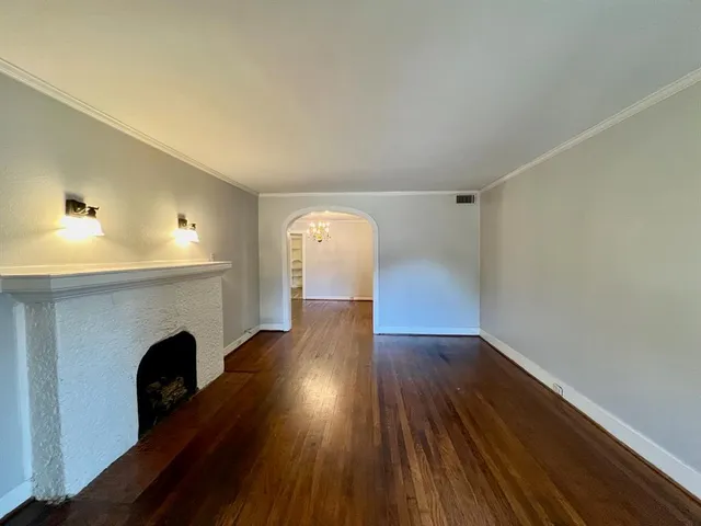 a view of livingroom with fireplace and wooden floor