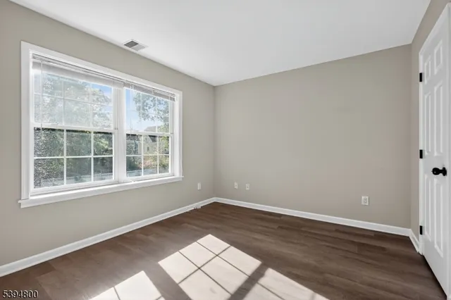 a view of wooden floor and windows in a room