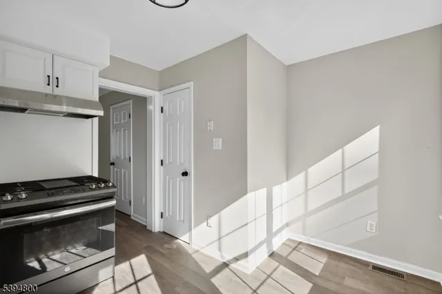 a view of kitchen with sink and cabinets