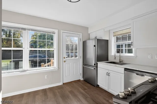 a kitchen with stainless steel appliances granite countertop a refrigerator and a sink