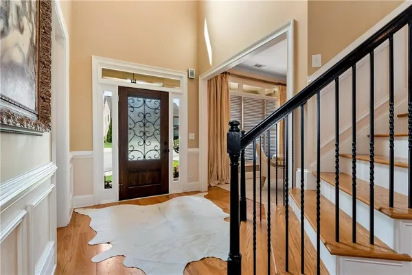 a dining room with furniture a chandelier and wooden floor