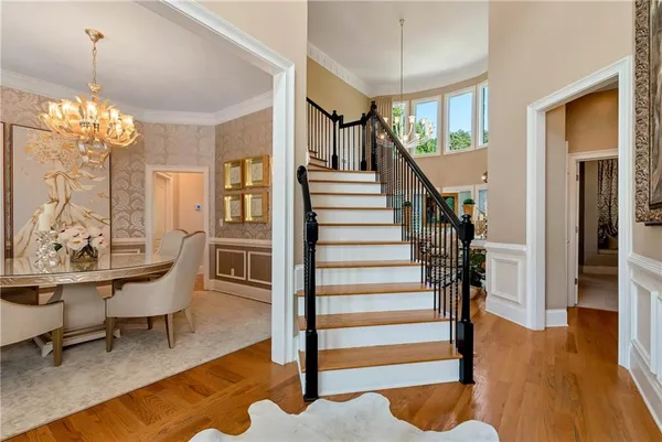 a view of a dining room with furniture and a chandelier