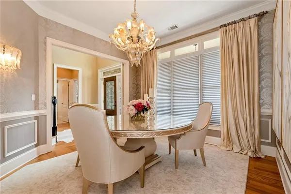 a living room with furniture a fireplace and a large window