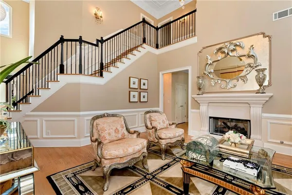 a dining room with furniture a chandelier and wooden floor