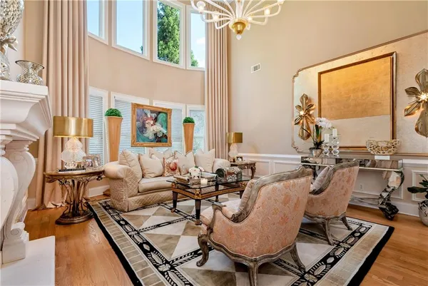 a kitchen with granite countertop stainless steel appliances a table chairs and a chandelier