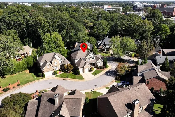 an aerial view of a house with outdoor space patio and trees all around