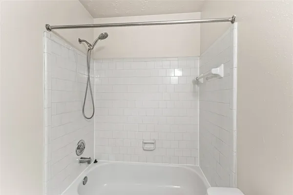 a bathroom with a shower and a bath tub